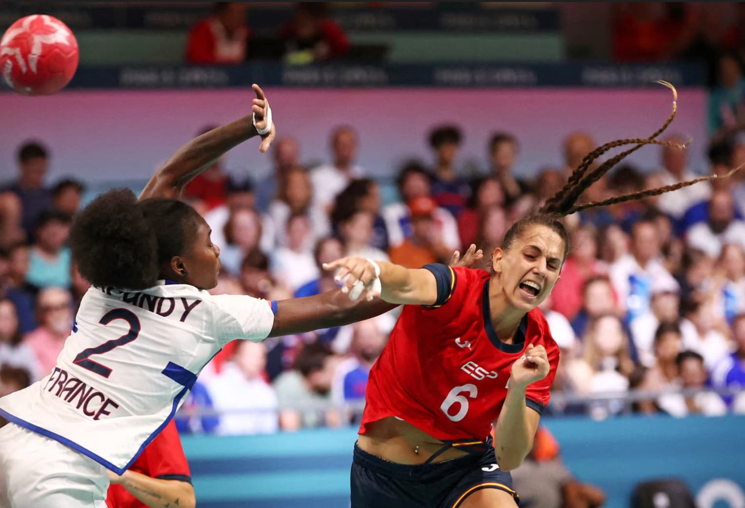 Spanish and French handball players duke it out during a preliminary round.